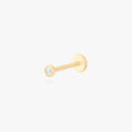 This is an image of a 14k gold flatback with a bezel setting and clear stone on ear.