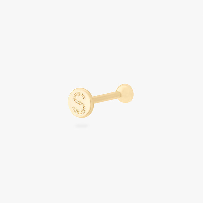 This is an image of a 14k gold flatback with a bezel setting and clear stone on ear. color:null|14k gold