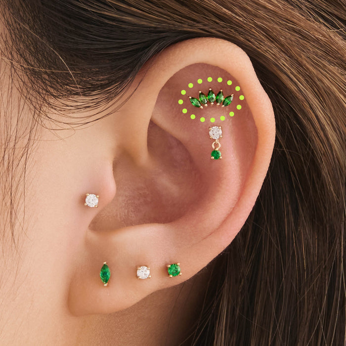 This is an image of a 14k gold flatback with a crown marquise cz setting and green cz stone on ear.