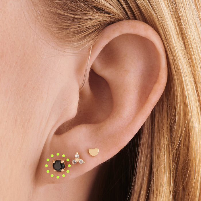 on ear featuring a 14k 4mm cz flatback stud with a black cz stone