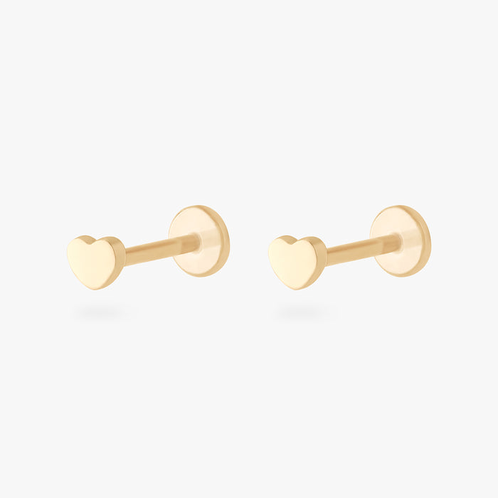 This image shows a pair of 14k yellow gold heart flatback studs
