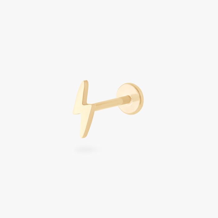This is an image of a 14k gold flatback stud that is shaped like a lightning bolt.