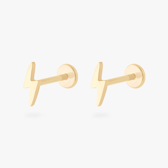 This is an image of a pair of 14k gold flatback studs that are shaped like lightning bolts.
