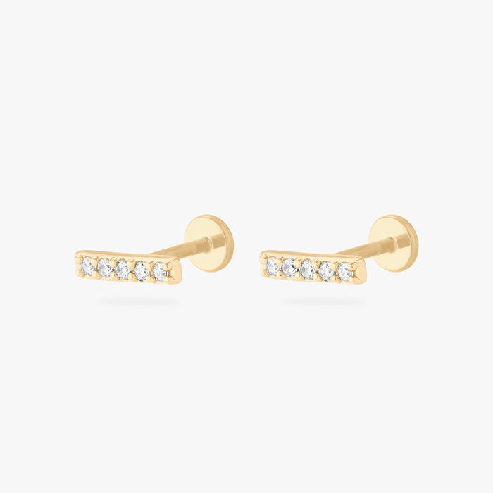 This image shows a pair of 14k pave bar flatback studs with five CZ stones