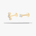 This image displays a set of two 14K gold flatback studs and a flatback insertion tool. The two earrings included in this set are the 14K Mini CZ Flatback Stud in gold/cleat, as well as the 14K Cluster Flatback Stud in gold/clear.