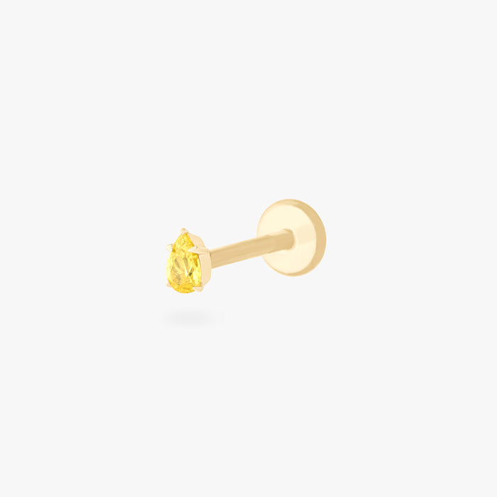 This is an image of a 14K gold flatback stud with a pear shaped topaz cz stone against a white background.