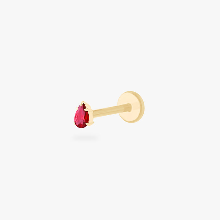 This is an image of a 14K gold flatback stud with a pear shaped garnet cz stone against a white background.
