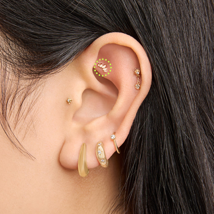 This is an image of a 14k gold flatback stud that is a solid gold crown marquise shape on ear. [hover] color:null|14k gold
