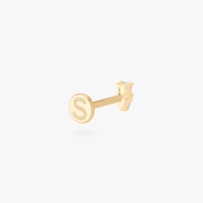 This is an image of a gold flatback stud with a clear stacked cz stone.