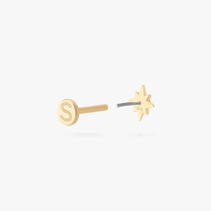 This is an image of a 14K gold flatback stud with a pointed star with a green cz stone in the center. color:null|gold/green
