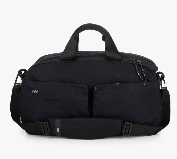 black Pakt. duffel bag with shoulder strap, dual front pockets, and top handles