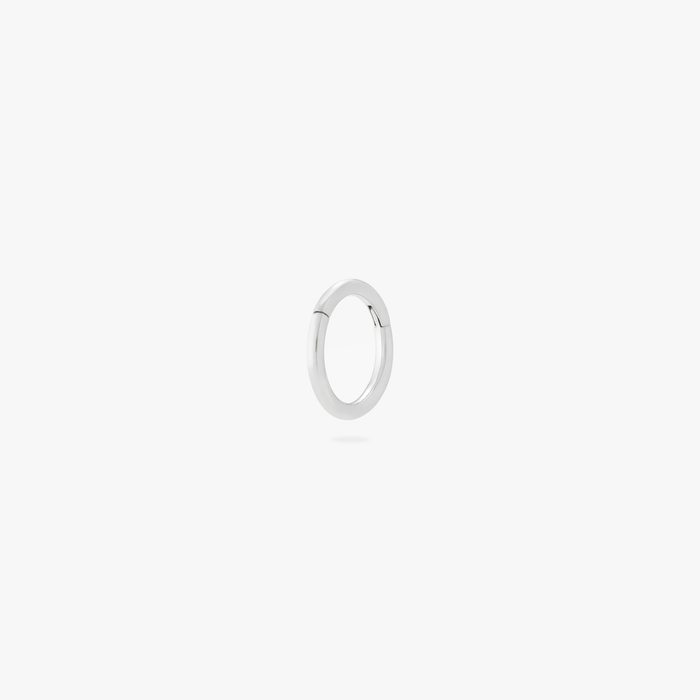 This is an image of a silver-toned titanium clicker with a 5mm diameter and hinge closure.