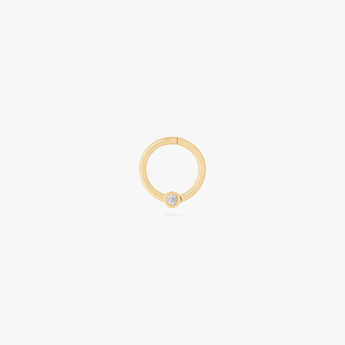 This image shows a 14k gold plated titanium front face clicker with a clear cz