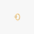 This is an image of a gold-toned titanium clicker with a twinkle-star shape that features a crystal CZ in the center. This clicker is 6mm in diameter.