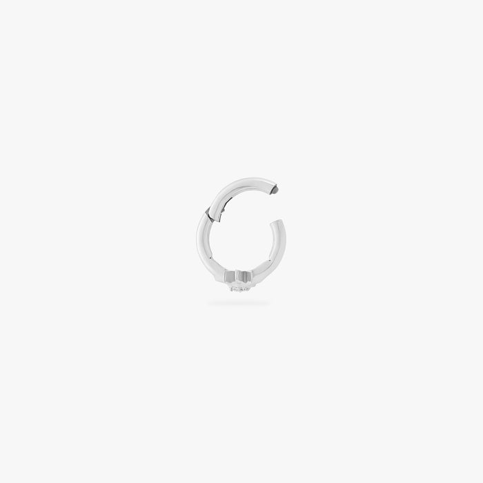 This is an image of a silver-toned titanium clicker with a twinkle-star shape that features a crystal CZ in the center. This clicker is 6mm in diameter.