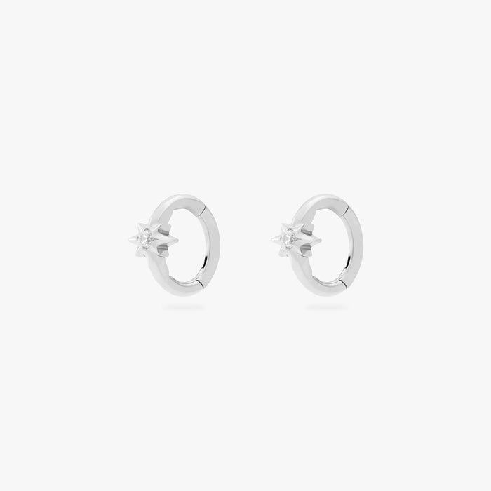 This is an image of a pair of silver-toned titanium clickers with twinkle-star shapes that feature crystal CZs in the center. These clickers are 6mm in diameter.