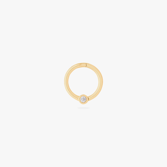 this image shows a 14k gold plated titanium front face clicker with a clear cz