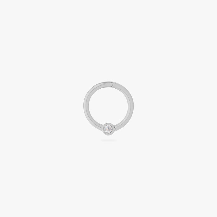 this image shows a 14k white gold plated titanium front face clicker with a clear cz