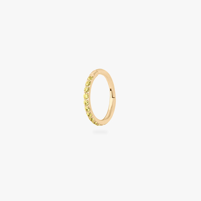This is a gold toned clicker with topaz cz stones. color:null|topaz