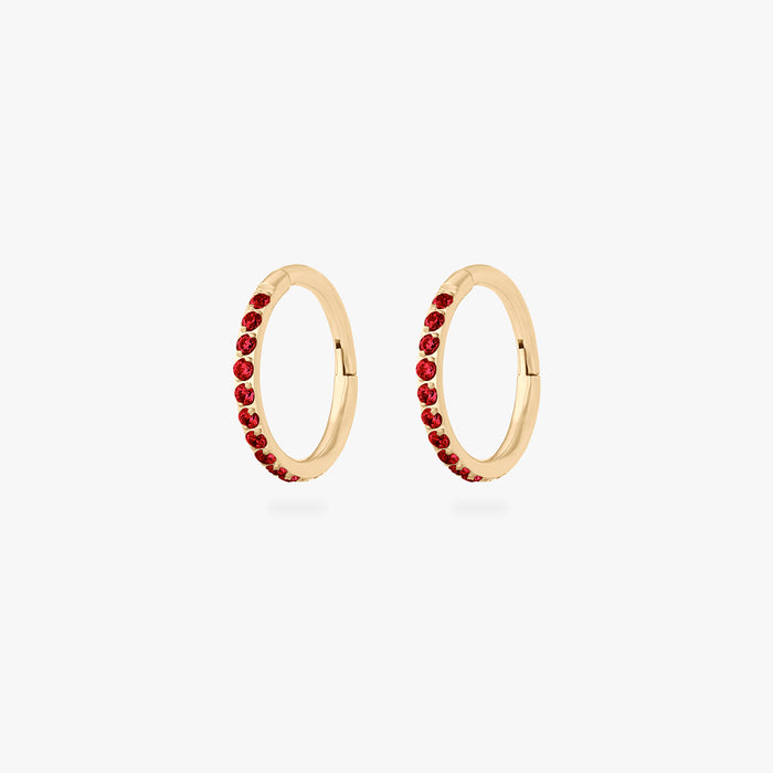 This is a pair of gold toned clickers with garnet cz stones. [pair] color:null|garnet