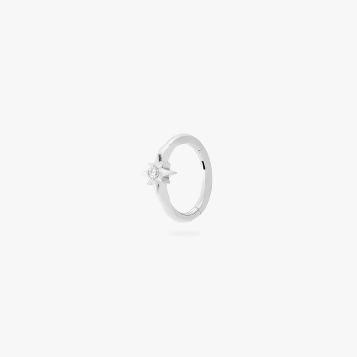 A single silver earring with a star-shaped stone, shown against a white background.