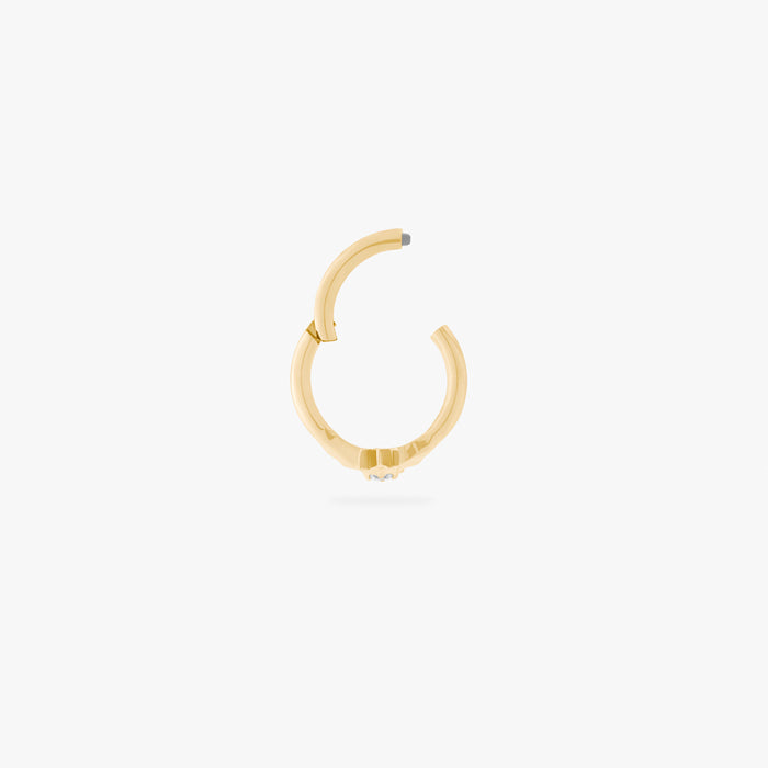 A single gold clicker with a star-shape featuring a crystal CZ stone, shown against a white background. This clicker is hinged open in this image.