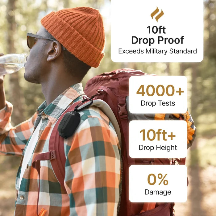 A man hikes in a forest, wearing sunglasses, an orange beanie, and a plaid shirt. He carries a red backpack with a Catalyst Case US AirPods (Gen 3) caseÃƒÂ¢Ã¢â€šÂ¬Ã¢â‚¬Âwaterproof to 330ft and drop proof, tested over 4000 times for 0% damage at 10ft+.