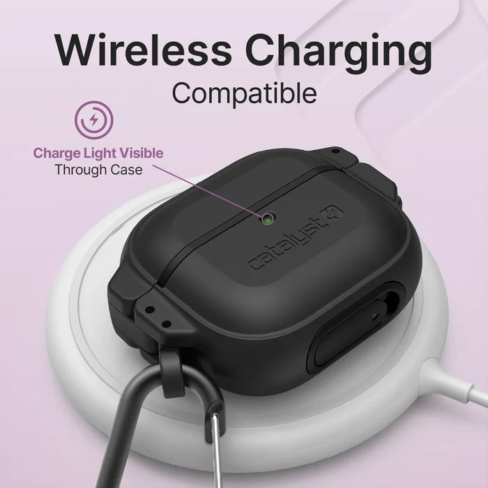 The Catalyst Case US AirPods (Gen 3) - 330ft Waterproof Total Protection Case + Carabiner sits on a white wireless charger, showing off its charging compatibility. A purple arrow highlights the visible charge light through the case.
