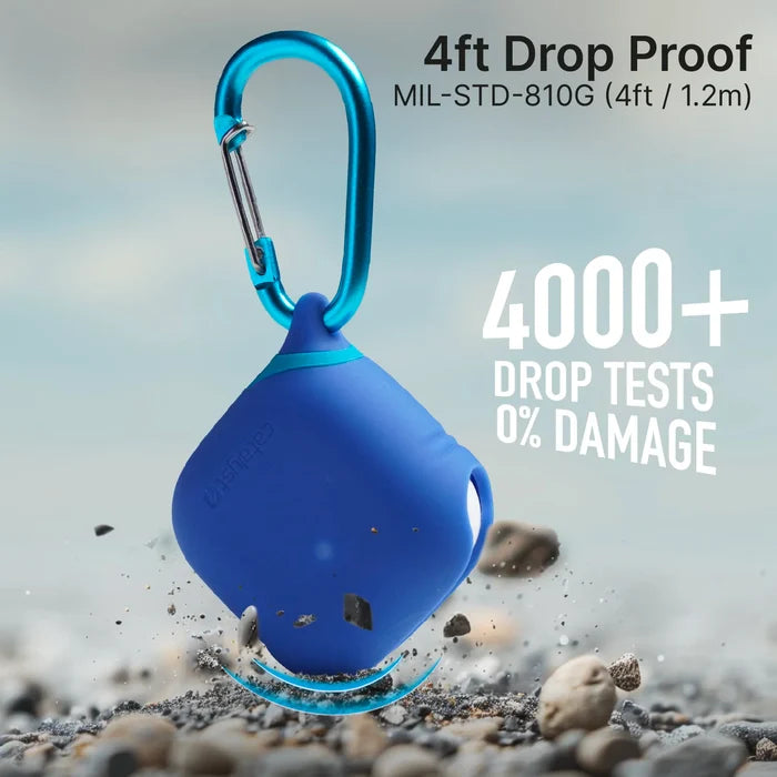A Catalyst Case US AirPods 5/4 Waterproof Case + Carabiner floats above rocky ground, showcasing its durability with "4ft Drop Proof MIL-STD-810G (1.2m)" and "4000+ Drop Tests 0% Damage" shown on a blurred background.