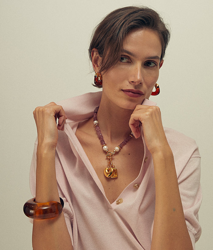 Model in pink shirt wears Arc Cuff and Organic Hoops in Tortoise with Mood Necklace in Strawberry quartz