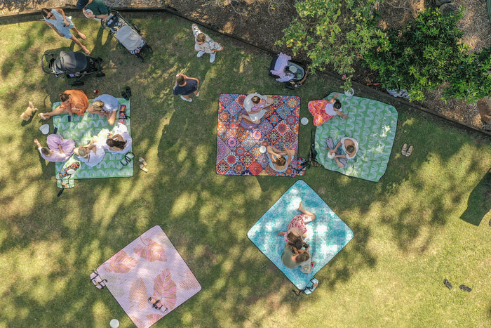 Drone aerial view of Nakie picnic blankets spread out, showcasing outdoor leisure and sustainability from above.