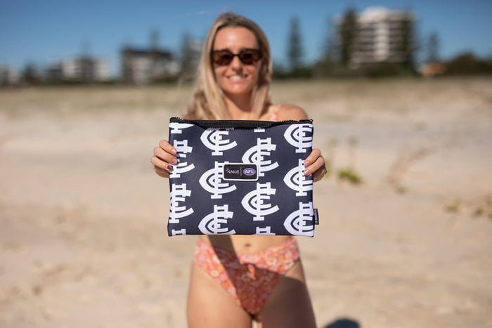 Carlton Blues navy sand-free beach towel with white repeating logo pattern, displayed on beach