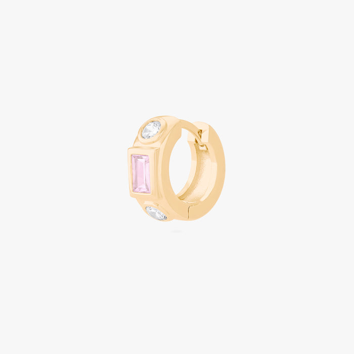 This image shows the front view of a 14k gold plated huggie with  cz stones. One pink square in the middle and two clear circular stones on the outside.