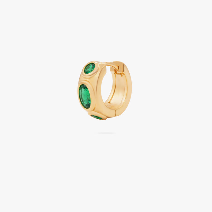 this image shows the front of a 14k gold plated huggie with three green circular cz stones