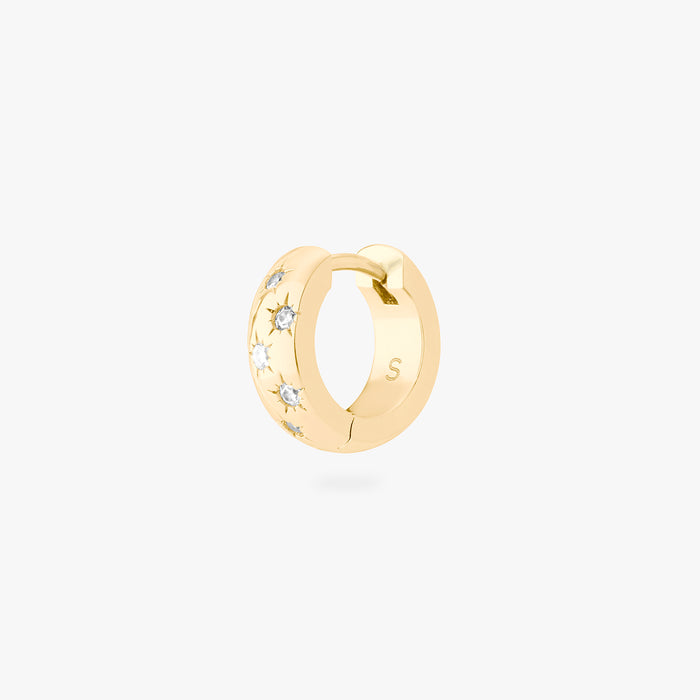 This image displays a 14K gold plated chunky huggie that features twinkle star shaped engravings with crystal CZ stones throughout the huggie against a white background.