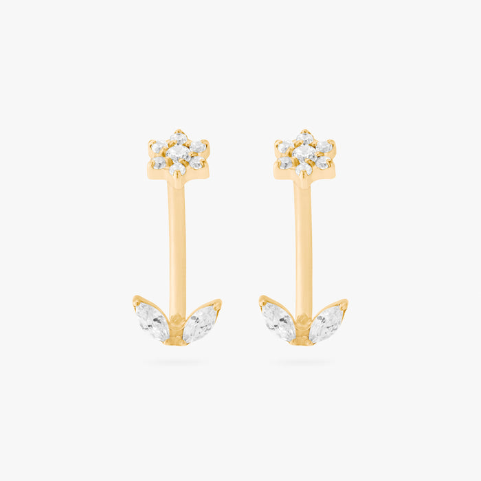 This is an image of a pair of gold-toned titanium curved barbells with crystal CZs in the shape of flowers on one end of each bar, and crystal CZs in the shape of leaves on the other end of each bar.