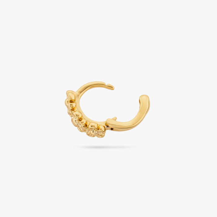 This is three small gold daisy-shaped flowers on a micro huggie with the clasp undone color:null|gold