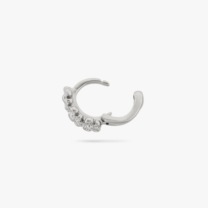 This is a micro huggie with three small silver daisy-shaped flowers color:null|silver