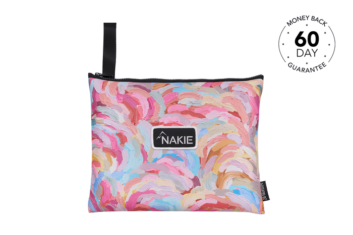 Colorful abstract brush stroke print recycled beach towel with black carry handle and Nakie logo label