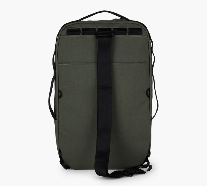 Back view of Everyday 15L Bag in Forest showing convertible sling strap, padded back panel, and top handle on white background
