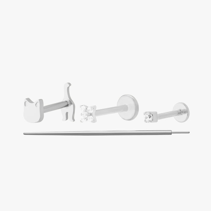 Set of 3 silver flatback earrings that comes with a reversible cat, a pave x, a mini cz, and a flatback insertion tool