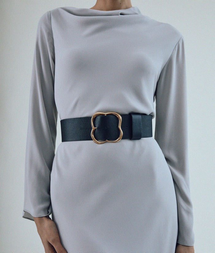 Straight-on close-up of model in grey dress with Florence Belt in Black and Gold.