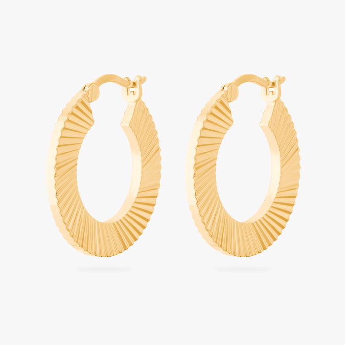 This is an image of a pair of 14K gold plated hoops that have a fluted, shell-like finish.