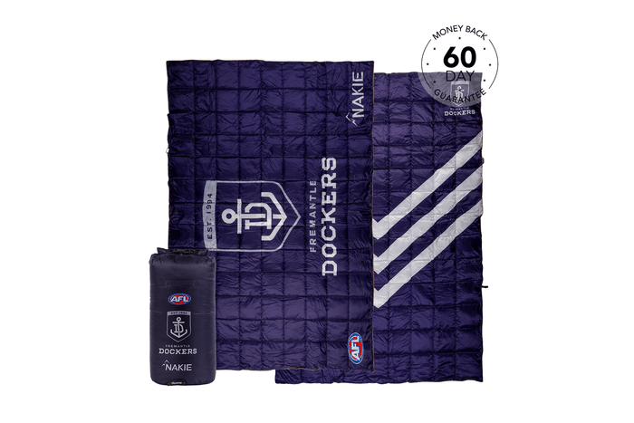Navy quilted puffy blanket with Fremantle Dockers AFL branding, displayed open with matching compression bag