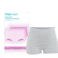 Packaging and a pair of gray boyshort disposable postpartum underwear designed by Frida Mom.