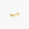 Gold stud earring on a white background