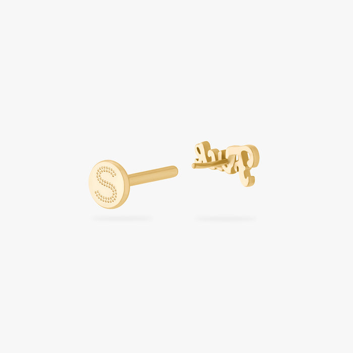 Gold stud earring on a white background showing earring back