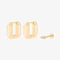 Gold earscape set with a pair of geometric huggies and a micro bezel flatback with a clear stone
