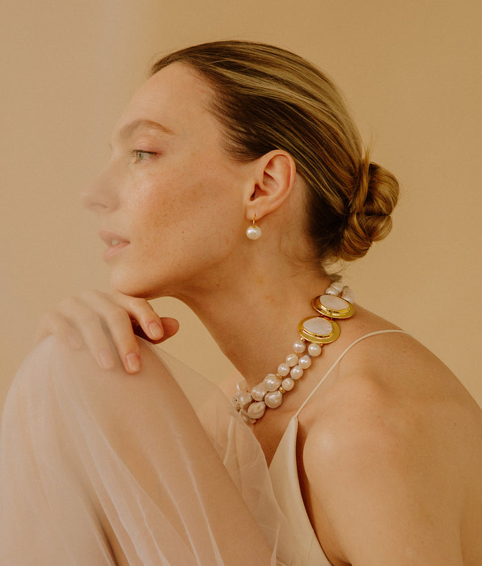 Model in profile wears Girl with Pearl Earrings in Frost and Monte Palace Necklace.