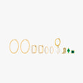 This image shows a set of 14k Yellow Gold plated earrings. The set includes one thin hoop pair, two pairs of huggies. One square shaped with clear cz stones and another with pearl cz stones. There is a singular open pearl huggie and three singular studs. There is a cowboy boot, a marquise with a green cz stone and a green cz stone stud flatback.